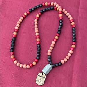 Hand assembled beaded necklace with metal pendant believe in yourself